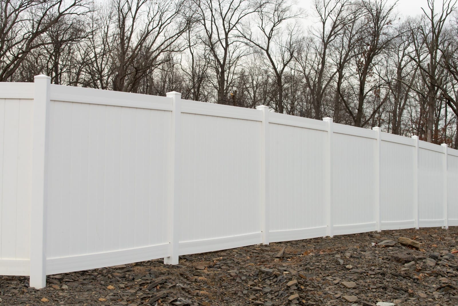 custom fencing solutions Jacksonville FL - White vinyl fence surrounding a modern home in a residential neighborhood, illustr